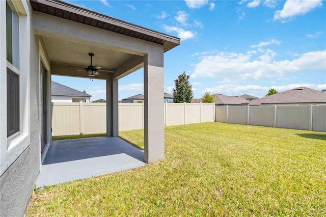 9629 Ivory Dr, Ruskin, FL 33573 - fenced backyard with ceiling fan and a patio area
