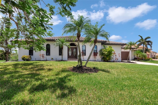 355 Trieste Dr, Punta Gorda, FL 33950 - mediterranean / spanish home with an attached garage, driveway, a front lawn, and stucco siding