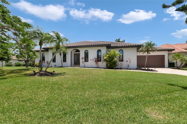 355 Trieste Dr, Punta Gorda, FL 33950 - mediterranean / spanish-style home with an attached garage, stucco siding, driveway, and a front lawn