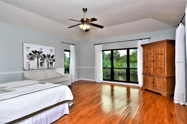 355 Trieste Dr, Punta Gorda, FL 33950 - bedroom featuring wood finished floors, a textured ceiling, and a ceiling fan