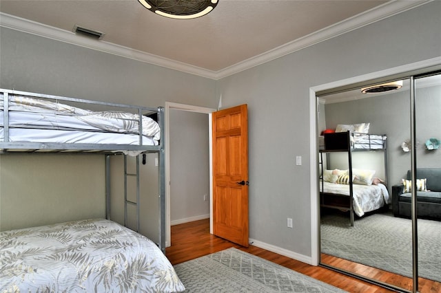 355 Trieste Dr, Punta Gorda, FL 33950 - bedroom featuring a closet, crown molding, and wood finished floors