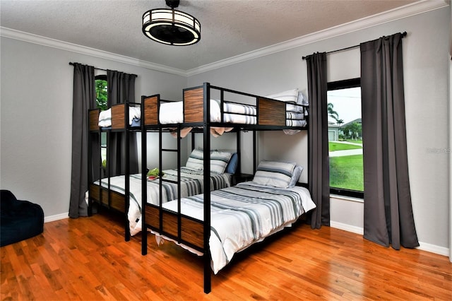 355 Trieste Dr, Punta Gorda, FL 33950 - bedroom featuring multiple windows, wood finished floors, ornamental molding, and a textured ceiling