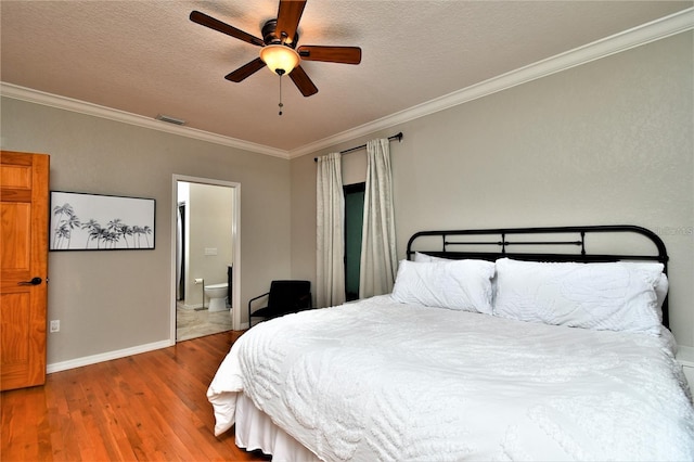 355 Trieste Dr, Punta Gorda, FL 33950 - bedroom featuring wood finished floors, ornamental molding, ensuite bathroom, a textured ceiling, and ceiling fan