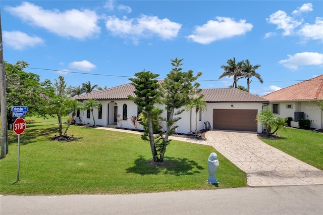 355 Trieste Dr, Punta Gorda, FL 33950 - mediterranean / spanish-style home featuring decorative driveway, stucco siding, a garage, and a tile roof