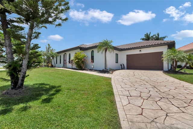 355 Trieste Dr, Punta Gorda, FL 33950 - mediterranean / spanish house featuring stucco siding, decorative driveway, a garage, a front yard, and a tile roof