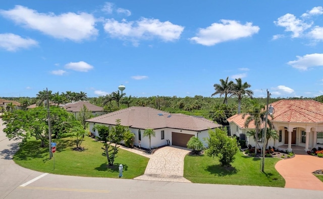 355 Trieste Dr, Punta Gorda, FL 33950 - view of front of home featuring a garage, a front lawn, stucco siding, decorative driveway, and a tile roof