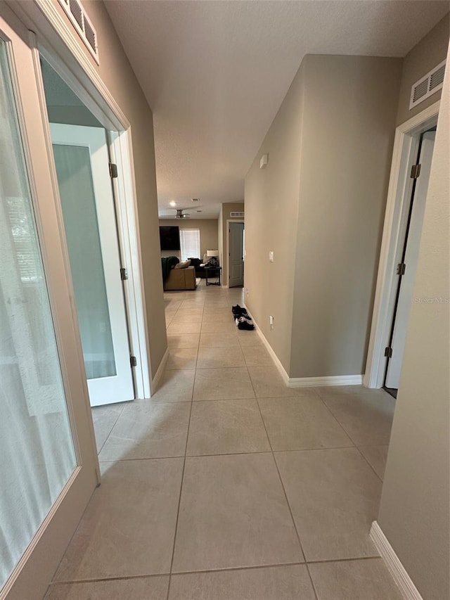 6 Pine Bluff Ln, Palm Coast, FL 32164 - corridor with light tile patterned flooring and baseboards