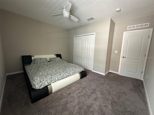 6 Pine Bluff Ln, Palm Coast, FL 32164 - bedroom with a closet, a textured ceiling, dark colored carpet, and a ceiling fan