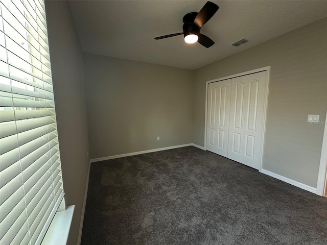 6 Pine Bluff Ln, Palm Coast, FL 32164 - unfurnished bedroom with dark colored carpet, a closet, and ceiling fan