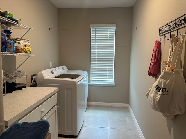 6 Pine Bluff Ln, Palm Coast, FL 32164 - laundry area featuring washing machine and clothes dryer, cabinet space, and light tile patterned floors