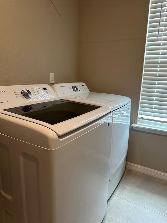 6 Pine Bluff Ln, Palm Coast, FL 32164 - laundry area featuring washing machine and dryer and light tile patterned floors