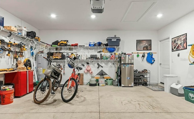 6 Pine Bluff Ln, Palm Coast, FL 32164 - garage featuring a garage door opener, a workshop area, recessed lighting, and water heater
