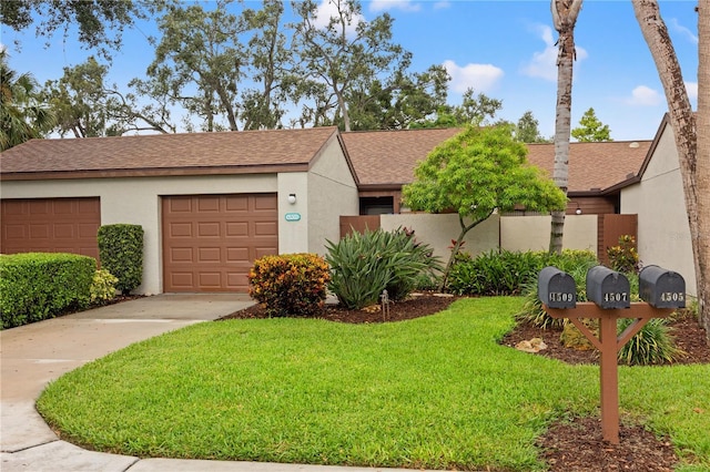 4509 Park Lake Ter N Unit 4509, Bradenton, FL 34209 - view of front facade with roof with shingles, a front lawn, stucco siding, and driveway