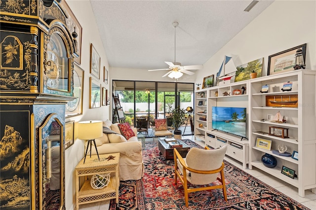 4509 Park Lake Ter N Unit 4509, Bradenton, FL 34209 - tiled living room featuring a ceiling fan, vaulted ceiling, and a textured ceiling