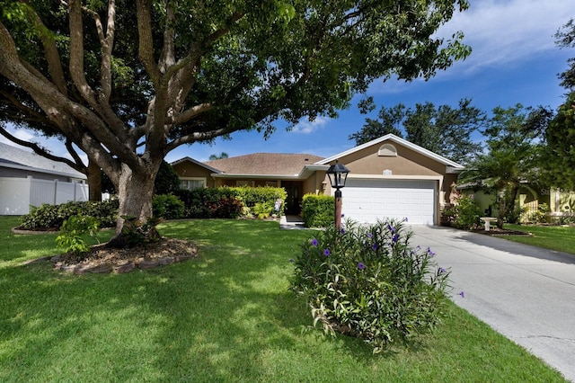 6115 68th Dr E, Palmetto, FL 34221 - ranch-style house featuring a garage, a front lawn, concrete driveway, and stucco siding
