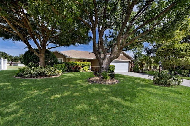6115 68th Dr E, Palmetto, FL 34221 - obstructed view of property with a garage, concrete driveway, a front yard, and stucco siding