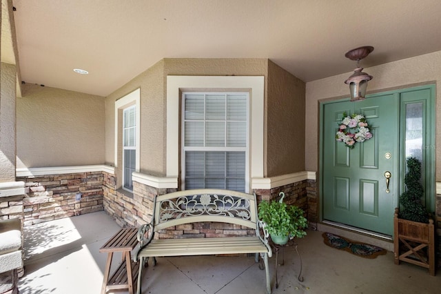 6115 68th Dr E, Palmetto, FL 34221 - property entrance featuring stone siding, stucco siding, and a porch
