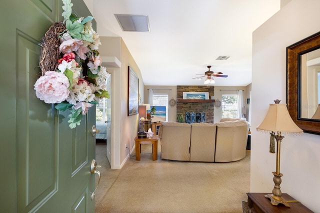 6115 68th Dr E, Palmetto, FL 34221 - living area featuring light colored carpet, ceiling fan, and a fireplace