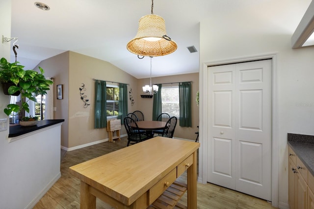 6115 68th Dr E, Palmetto, FL 34221 - dining space featuring a chandelier, light wood-type flooring, and vaulted ceiling