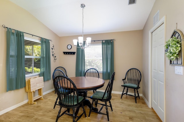 6115 68th Dr E, Palmetto, FL 34221 - dining room with light wood-type flooring, vaulted ceiling, and a chandelier