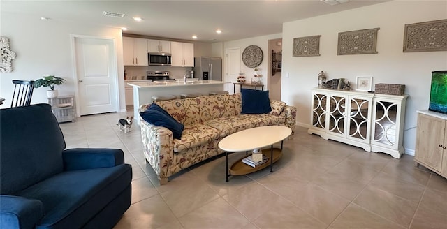 12293 Mountain Island Trl, Parrish, FL 34219 - living room featuring light tile patterned floors and recessed lighting