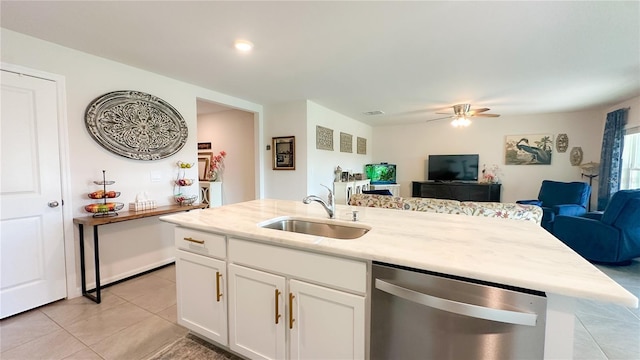 12293 Mountain Island Trl, Parrish, FL 34219 - kitchen featuring stainless steel dishwasher, open floor plan, light tile patterned floors, an island with sink, and white cabinets