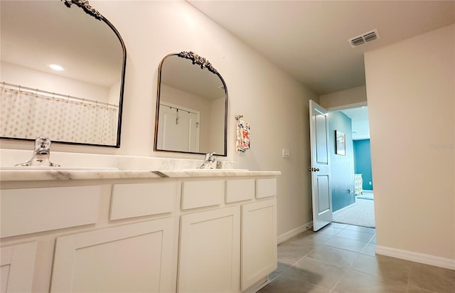 12293 Mountain Island Trl, Parrish, FL 34219 - full bathroom with double vanity and tile patterned flooring
