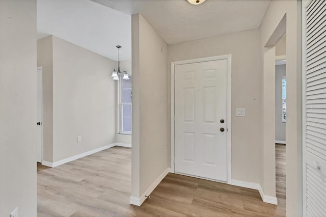 4050 Pinebrook Cir Unit 5, Bradenton, FL 34209 - foyer entrance with wood finished floors, plenty of natural light, and a chandelier