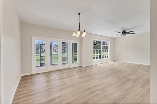 4050 Pinebrook Cir Unit 5, Bradenton, FL 34209 - unfurnished living room featuring light wood-style floors, a chandelier, french doors, and ceiling fan