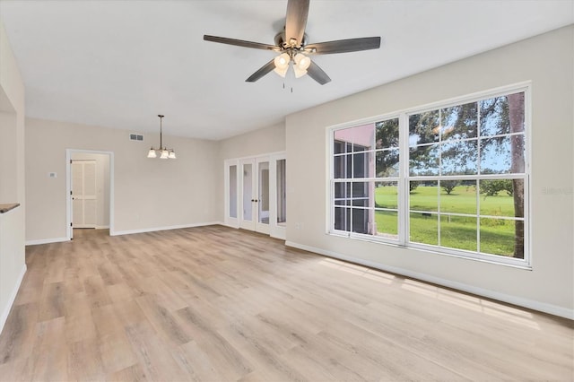 4050 Pinebrook Cir Unit 5, Bradenton, FL 34209 - unfurnished living room featuring a chandelier, light wood-type flooring, a ceiling fan, and french doors