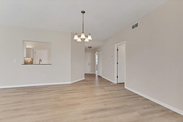 4050 Pinebrook Cir Unit 5, Bradenton, FL 34209 - spare room featuring a chandelier and light wood finished floors