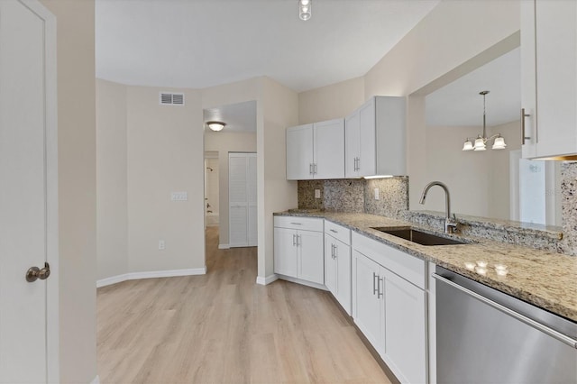 4050 Pinebrook Cir Unit 5, Bradenton, FL 34209 - kitchen featuring dishwasher, light wood finished floors, light stone countertops, decorative backsplash, and white cabinetry