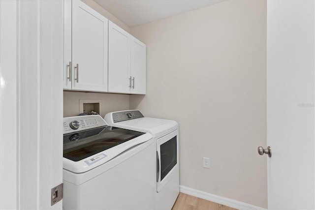 4050 Pinebrook Cir Unit 5, Bradenton, FL 34209 - washroom featuring independent washer and dryer, cabinet space, and light wood-style flooring