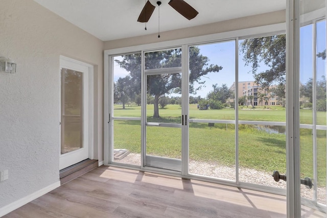 4050 Pinebrook Cir Unit 5, Bradenton, FL 34209 - unfurnished sunroom featuring a textured wall, healthy amount of natural light, and wood finished floors