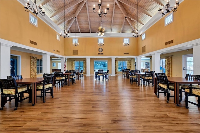 4050 Pinebrook Cir Unit 5, Bradenton, FL 34209 - dining area with a wood ceiling with exposed beams, high vaulted ceiling, a chandelier, decorative columns, and wood-type flooring
