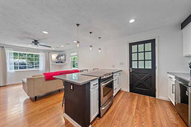 626 Hand Ave, Sarasota, FL 34232 - kitchen featuring stainless steel range with electric stovetop, light wood-style flooring, white cabinetry, and recessed lighting