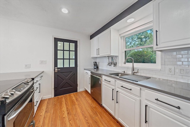 626 Hand Ave, Sarasota, FL 34232 - kitchen featuring stainless steel appliances, decorative backsplash, light wood-style floors, white cabinets, and recessed lighting