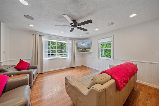 626 Hand Ave, Sarasota, FL 34232 - living room featuring wood finished floors, ceiling fan, wainscoting, recessed lighting, and a textured ceiling
