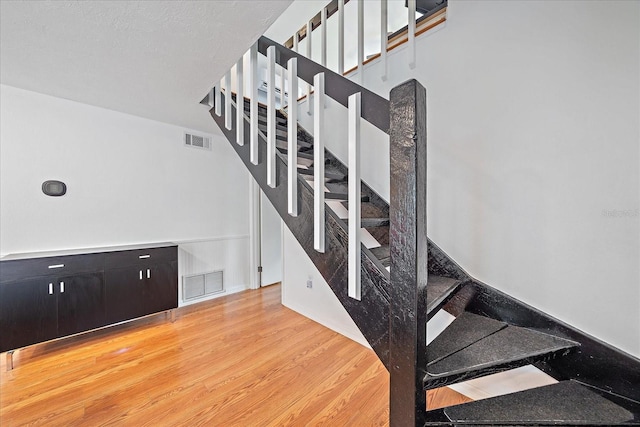 626 Hand Ave, Sarasota, FL 34232 - stairs with wood finished floors