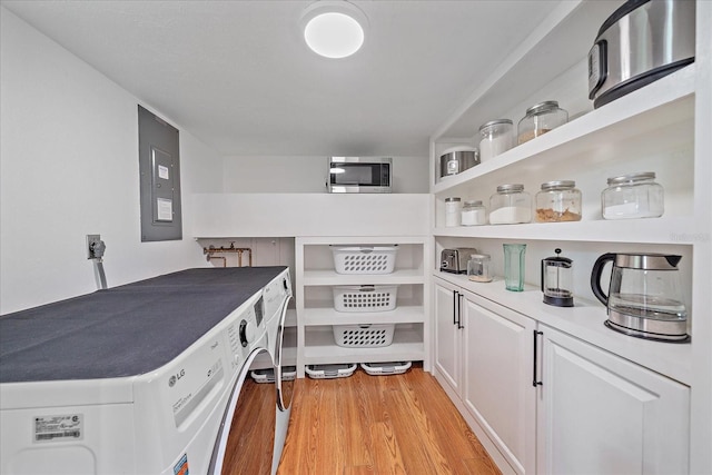626 Hand Ave, Sarasota, FL 34232 - storage area featuring washer / dryer and electric panel