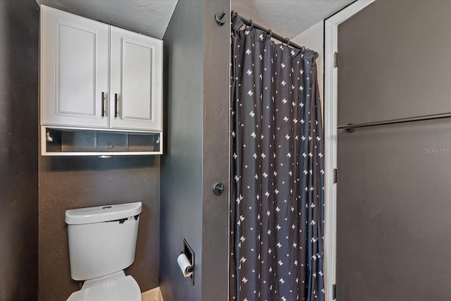 626 Hand Ave, Sarasota, FL 34232 - bathroom featuring toilet and a shower with shower curtain