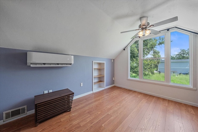 626 Hand Ave, Sarasota, FL 34232 - unfurnished living room featuring a wall mounted air conditioner, built in features, lofted ceiling, a ceiling fan, and wood finished floors