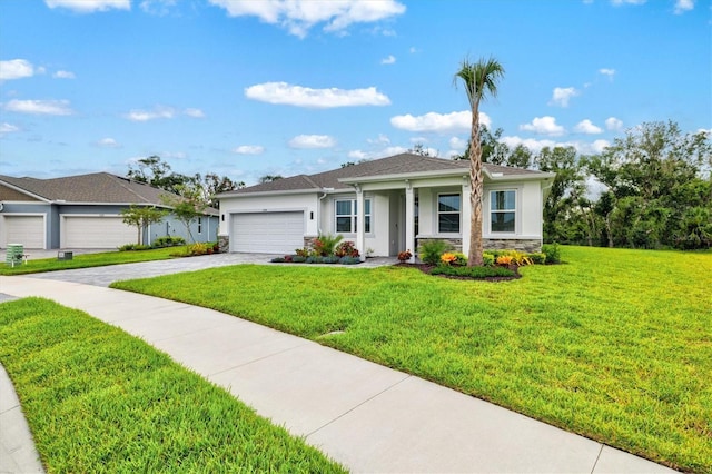 5318 124th Ave E, Parrish, FL 34219 - view of front of home with stucco siding, stone siding, a garage, driveway, and a front yard
