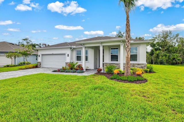 5318 124th Ave E, Parrish, FL 34219 - view of front of home featuring stone siding, stucco siding, a garage, decorative driveway, and a front yard
