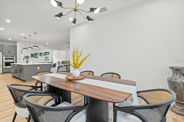 5318 124th Ave E, Parrish, FL 34219 - dining area featuring light wood-type flooring, recessed lighting, and a chandelier