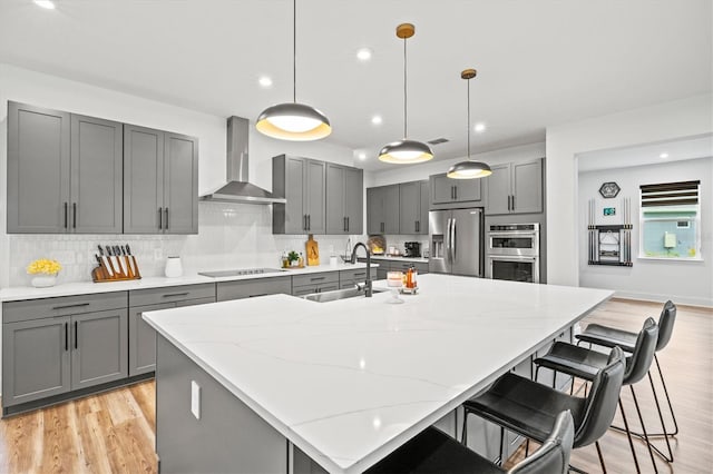 5318 124th Ave E, Parrish, FL 34219 - kitchen featuring gray cabinets, appliances with stainless steel finishes, light wood finished floors, backsplash, and recessed lighting