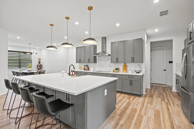 5318 124th Ave E, Parrish, FL 34219 - kitchen with gray cabinets, freestanding refrigerator, light wood-type flooring, recessed lighting, and tasteful backsplash