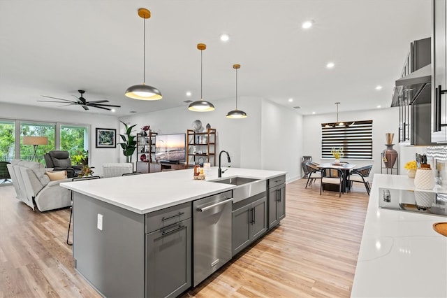 5318 124th Ave E, Parrish, FL 34219 - kitchen featuring light wood finished floors, stainless steel dishwasher, gray cabinetry, light countertops, and recessed lighting