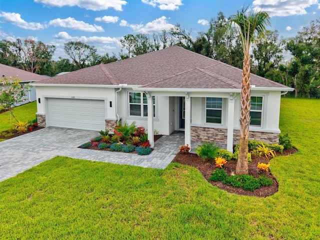 5318 124th Ave E, Parrish, FL 34219 - ranch-style house with stucco siding, stone siding, a garage, decorative driveway, and a front lawn