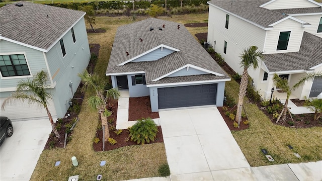 9084 Tequila Sunrise Dr, Sarasota, FL 34241 - view of front facade with roof with shingles, driveway, an attached garage, and stucco siding